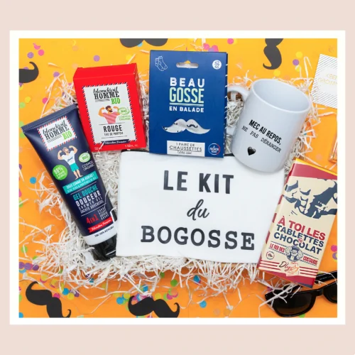 Cadeau homme inoubliable : une box avec produits de beauté pour homme, gel douche pour le corps, crème coiffante, trousse 'Le kit du Bogosse', eau de toilette, chaussettes 'Beau Gosse' et tablette de chocolat noir.